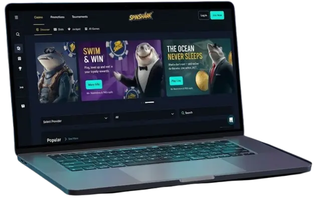 A modern silver laptop displaying the SpinShark Casino homepage against a black background, showcasing the platform's user interface and mobile compatibility to demonstrate the high-quality gaming experience for users.